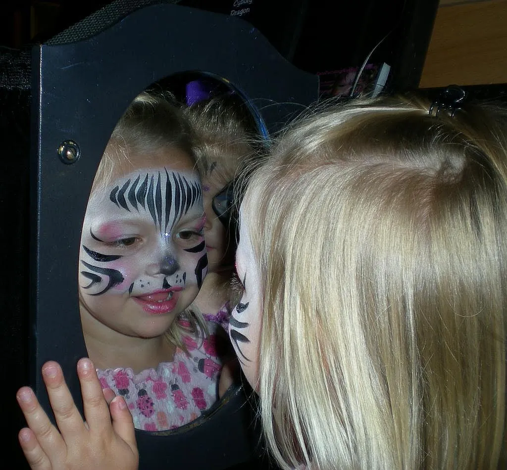 Zebra Reflecting from Face Painting and Balloons
